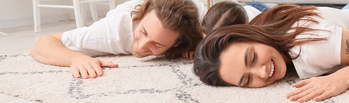 Happy couple enjoying comfort of area rug carpet