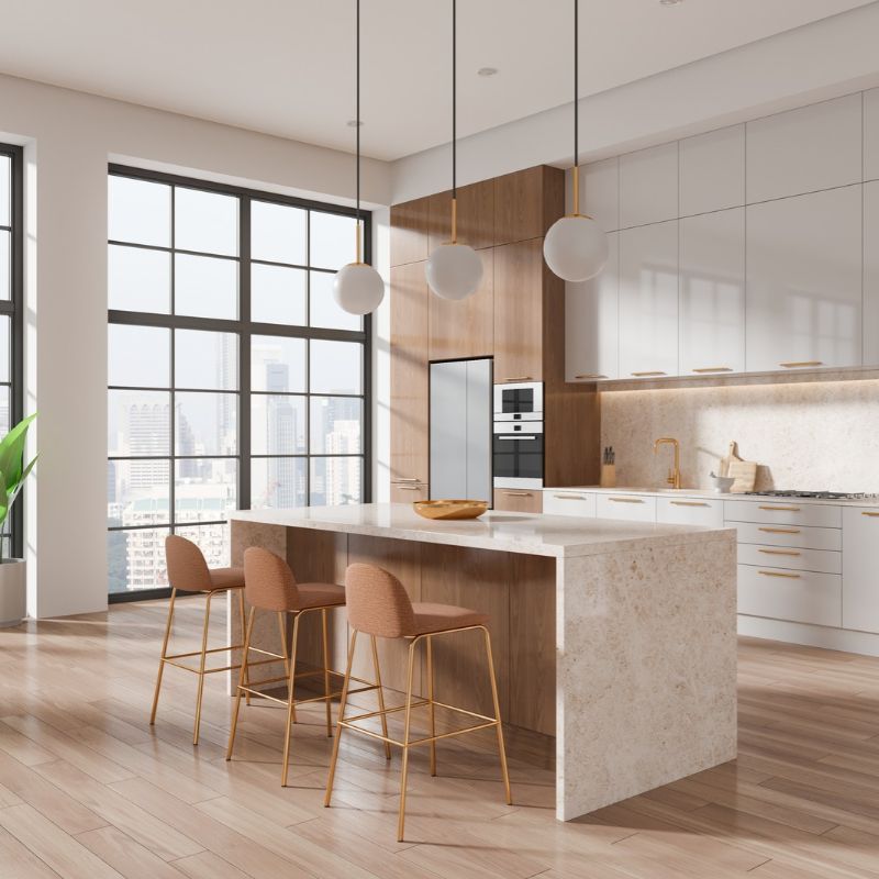  A modern kitchen featuring white cabinets and wooden floors, showcasing a clean and contemporary design.