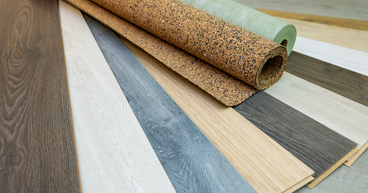 A display of various flooring types, including hardwood, laminate, and tile, showcasing different wood finishes and textures.