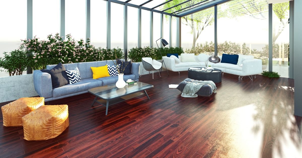 A spacious sunroom featuring a large glass wall and elegant wooden floors, creating a bright and inviting atmosphere
