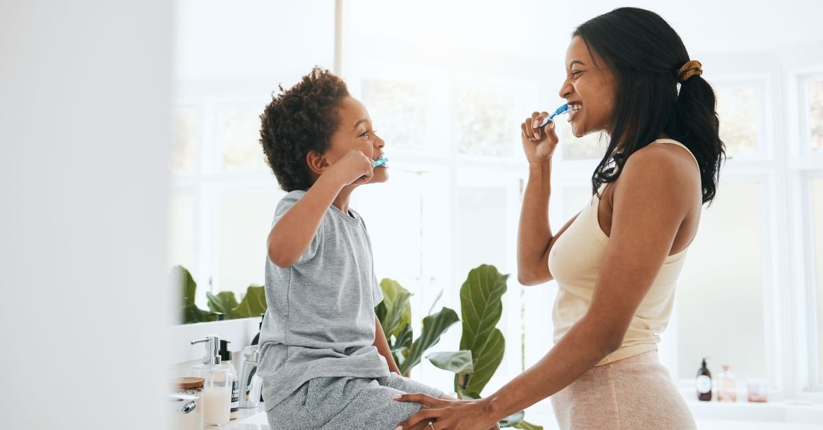 mom and son brushing teeth in small bathroom