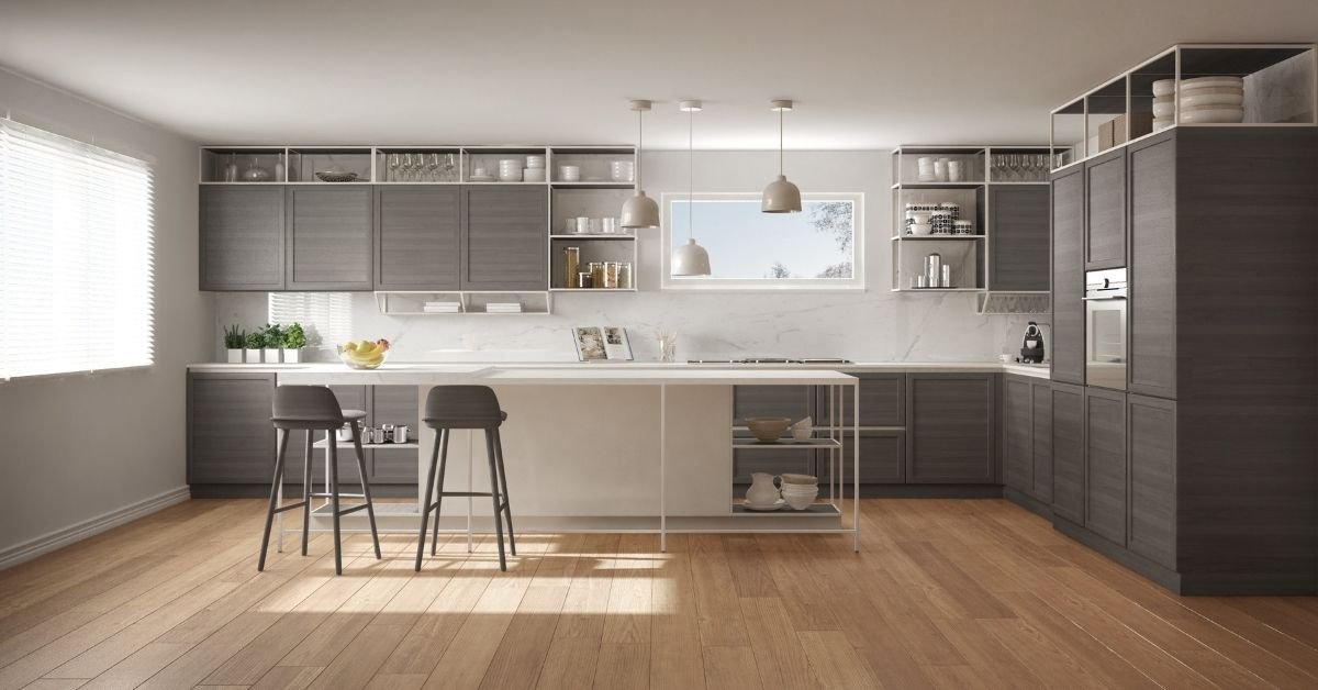A modern kitchen featuring wooden floors and sleek gray cabinets, creating a stylish and contemporary atmosphere.