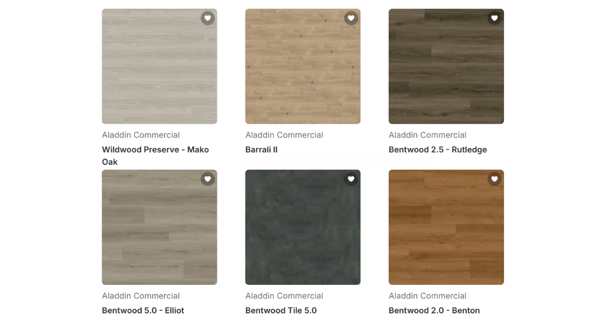 A collection of luxury vinyl flooring samples showcasing various colors and textures arranged neatly on a display surface.