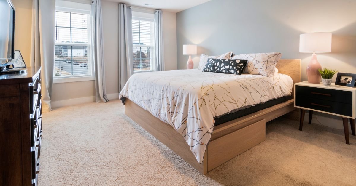 Platform Drawer Bed with White Linen in a Carpeted Room