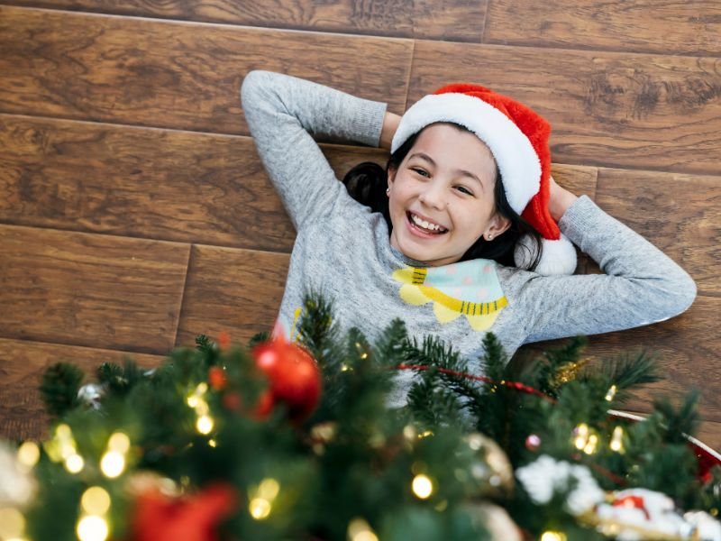 smiling child under christmas tree